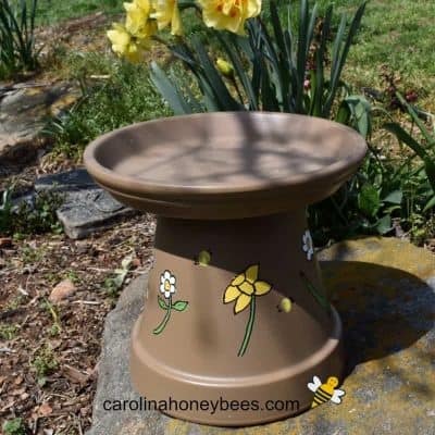 Bee watering station made from a clay pot image.