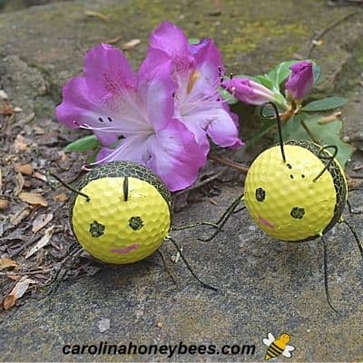 Bees made from old golf ball in the garden image.