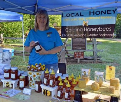 Beekeeper Charlotte selling honey at a local event image.