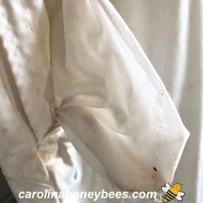 Empty pockets of beekeeping suit.