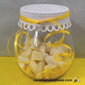 Scented soy beeswax tarts in a plastic container image.