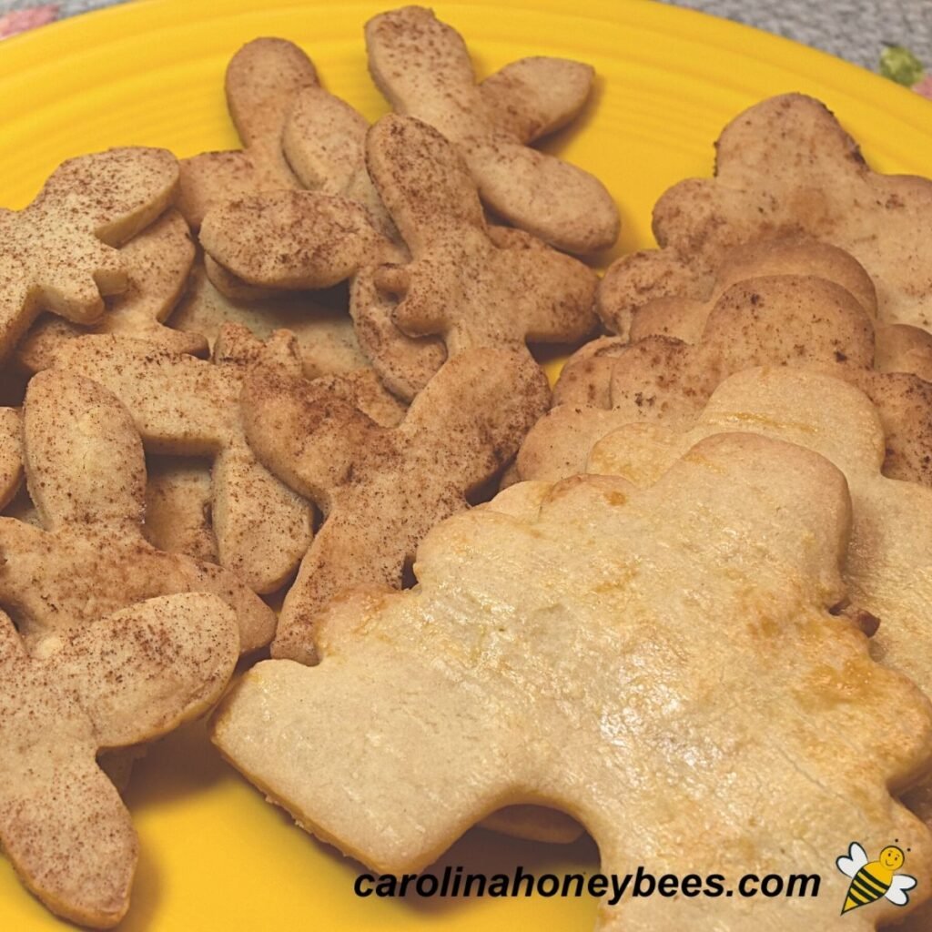 Bee theme shaped honey cookies on a yellow plate image.