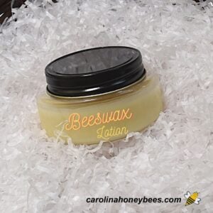 Small container of homemade beeswax lotion in a basket image.