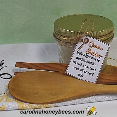 A jar of beeswax spoon butter and a wooden spoon makes a great gift of stocking stuffer image.