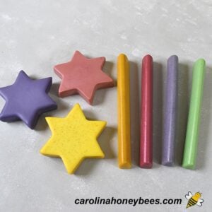 Homemade beeswax crayons in stick form and shapes image.