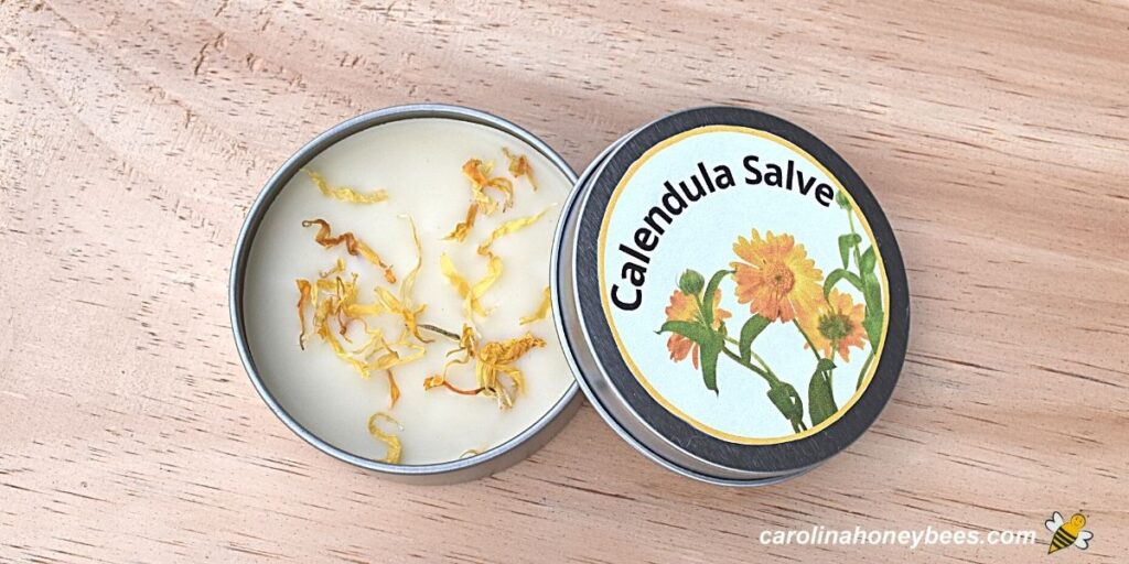 Finished tin of homemade herbal calendula salve with beeswax.