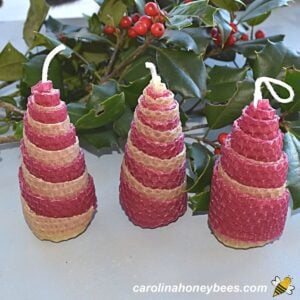 Trio of hand rolled beeswax christmas tree candles image.