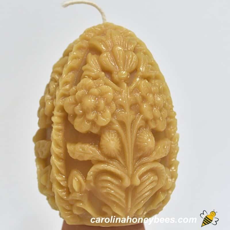 Carved egg shaped  beeswax candle made from mold.