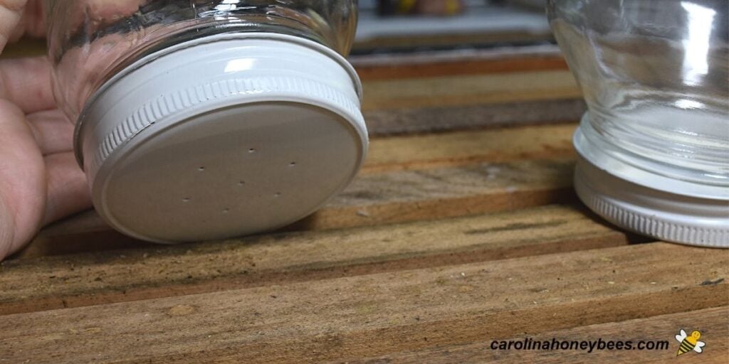 Using glass mason jars to feed a bee package.