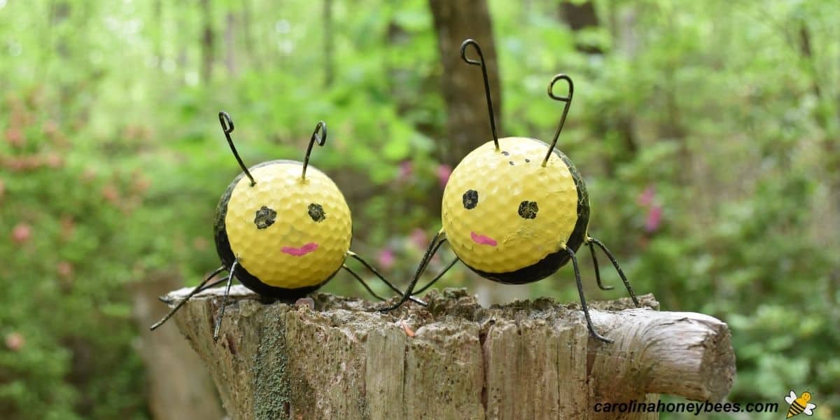 Two golf ball craft bees made with old golf balls.