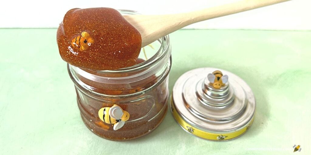 A jar of homemade honey slime with bees in glass jar.