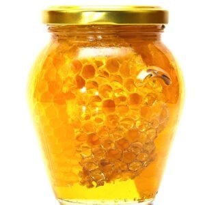 Small jars of amber colored chunk honey.