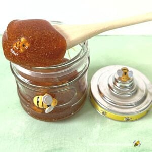 Honey slime with bees in glass jar.