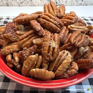 Honey roasted pecans in a red bowl.