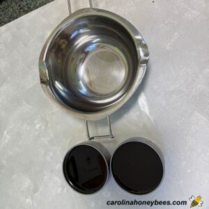 Black walnut and beeswax salve cooling in tins.