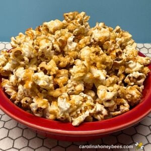 Popcorn made with honey and sea salt in a red bowl.