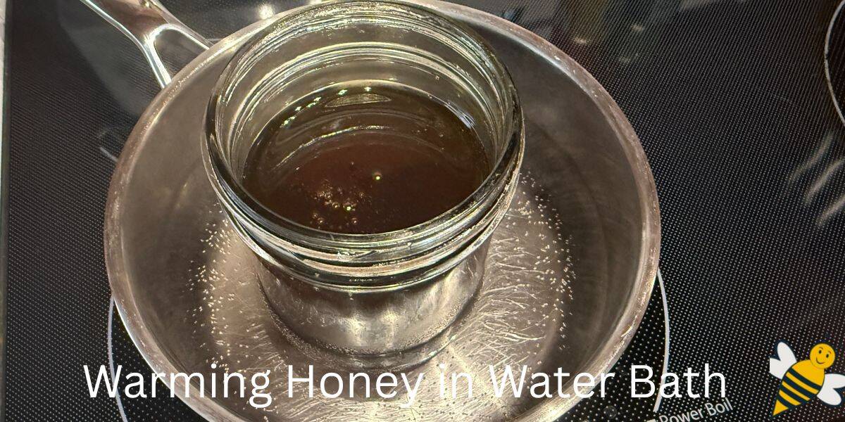 Gently warming honey in hot water bath on stove top.