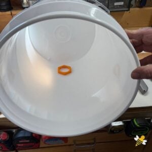 Plastic nut for gated honey bucket inside the pail.